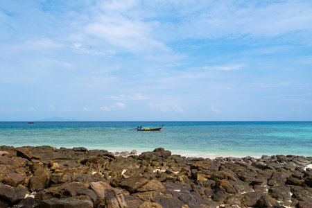 Long tailed boats near tropical beach at Ko Phi Phi, Thailand. Tropic beach with white sand and turquoise water, concept of vacation in paradise.の写真素材