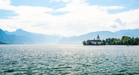 Schloss Ort castle near Traunsee, Austria. View of ancient castle with long bridge over lake. Famous tourist destination.のeditorial素材
