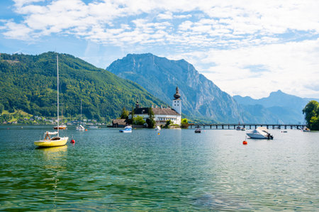 Schloss Ort castle near Traunsee, Austria. View of ancient castle with long bridge over lake. Famous tourist destination.のeditorial素材
