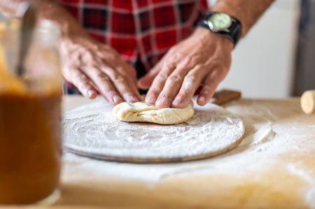 Detail of hands of men rolling the dough. Preparation for baking of traditional Czech pastry. Homemade fresh foodの写真素材