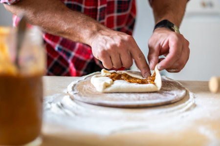 Detail of hands of men rolling the dough. Preparation for baking of traditional Czech pastry. Homemade fresh foodの写真素材