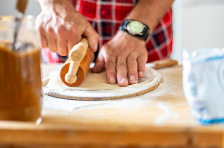 Detail of hands of men rolling the dough. Preparation for baking of traditional Czech pastry. Homemade fresh foodの写真素材