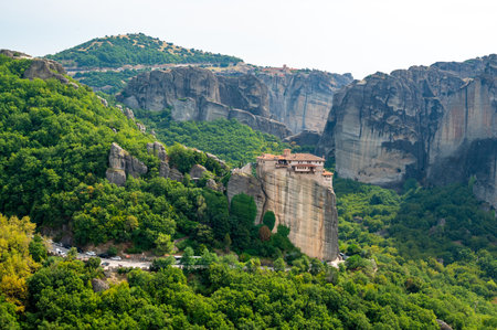 Monastery Meteora Greece. Stunning summer panoramic landscape. View at mountains and green forest...