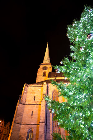 A festive scene with Christmas decorations in the foreground and the Cathedral of St. Bartholomew in Plzen, Czech Republic, in the background. A charming mix of tradition and holiday spiritの写真素材
