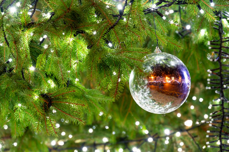 A beautiful glass ornament hanging on a Christmas tree, capturing the essence of the holiday spiritの写真素材