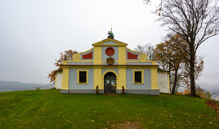 A scenic view of the Chapel of St. Mary of Sorrows at the summit of Krizovy vrch, near Cesky Krumlov, surrounded by nature, offering a peaceful and spiritual atmosphereの写真素材