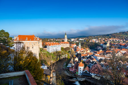 Panoramic view of Cesky Krumlov, showcasing the UNESCO-listed historic center surrounded by the Vltava River in a meander. A sunny autumn day highlights the town's charm.の写真素材