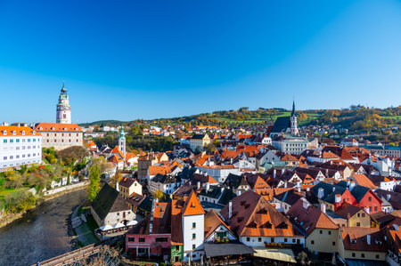 Panoramic view of Cesky Krumlov, showcasing the UNESCO-listed historic center surrounded by the Vltava River in a meander. A sunny autumn day highlights the town's charm.の写真素材