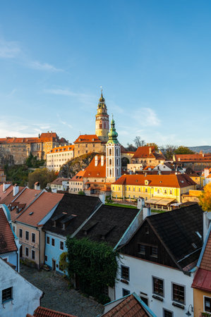 Panoramic view of Cesky Krumlov, featuring the historic castle tower and the church of St. John of Nepomuk. The medieval town's charm is beautifully captured on a sunny dayの写真素材