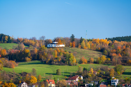 Krizova Hora near Cesky Krumlov with the Chapel of Our Lady of Sorrows at the summit. Captured in autumn with vibrant foliage and sunny weather highlighting its serene beautyの写真素材