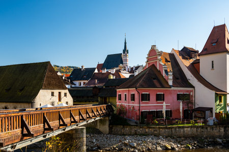 Church of St. Vitus in Cesky Krumlov surrounded by the historic town center. A sunny day with a clear blue sky highlights the charm of this UNESCO-listed medieval destinationの写真素材