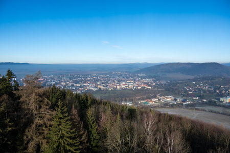 Aerial view of Moravska Trebova with its scenic panorama. The town is surrounded by rolling hills and dense forests, showcasing the harmony of historic architecture and Czech natureの写真素材