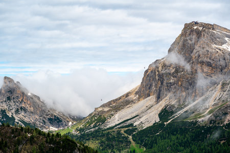 Mountain peak near Cinque Torri in the Dolomites (Dolomiti, Dolomiten), Italy. A cable car ascends to the summit, offering breathtaking alpine views and access to hiking trailsの写真素材