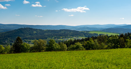 Ridge hiking trail from Javornik to Jested with scenic views into valleys and distant Jizera Mountains. Sunny summer day, peaceful nature and beautiful Czech landscapeの写真素材