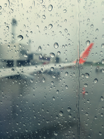 rain make the steam on the airplane window, You can't see the airplane and make you feel lonely.の写真素材