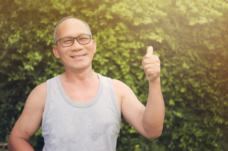 Healthy and happy,  Old man is Smiling on Green Grass background, soft focusの写真素材