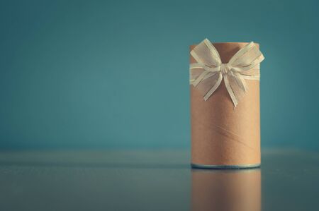 Gift box, Cylinder gift box with ribbons for  christmas, new year or celeblation holidays  on blue  background, Vintage color, copy space, copyright space.の写真素材