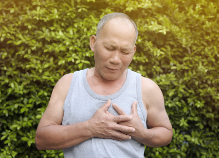Oldman heart failure on green natural background.の写真素材