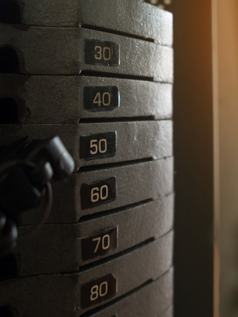 Close up gym equipment. Stack of old metal weights bodybuilding equipment.の写真素材