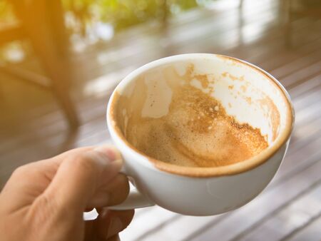 Close up man hand holding empty cup of coffee.の写真素材
