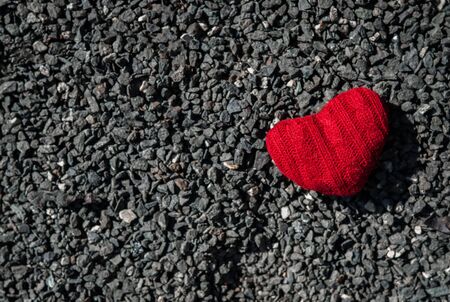 Valentine's concept. Red heart on dark grey gravel texture  background with copy space.の写真素材