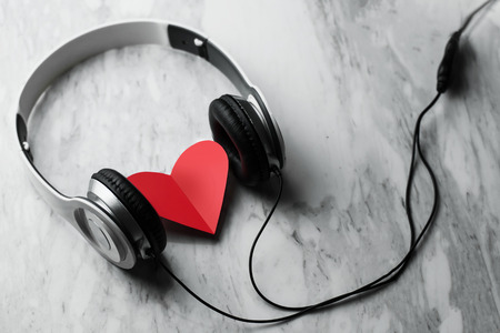 Happiness, Wellness concept. Top view of Red heart and headphone on white marble background. Copy space.の写真素材