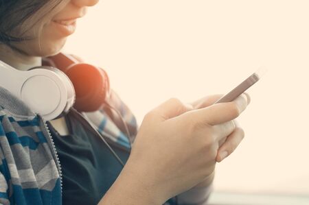 Happiness of Asian girl with headphone using smartphone for listening to the musicの写真素材