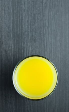 Close Up top view of orange juice in glass on wooden background.の写真素材