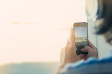 Woman taking photo with mobile phone.の写真素材