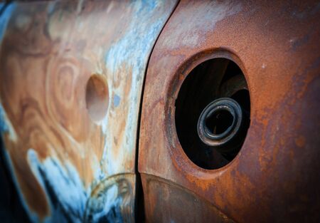 Close up of car gas tank and car body,  Car crash and burn  on the street after car on fire.の写真素材