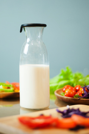 Milk in bottle with vegetables.の写真素材