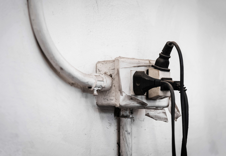 Close up of Old Multiple electricity plugs on old adapter risk overloading and dangerous.の写真素材