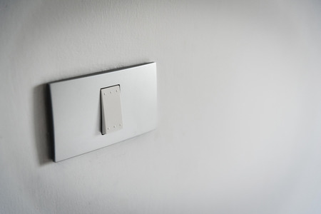 Close up grey light switch on texture background. Copy space.の写真素材