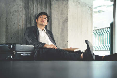 Frustrated Asian Businessman failing about his business. Stress, tired concept.の写真素材