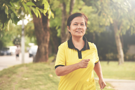 Asian senior woman relaxing with jogging at park outdoor. Happiness.の写真素材
