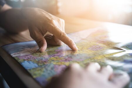 Tourist planning on vacation. Close up people hands on the map.の写真素材