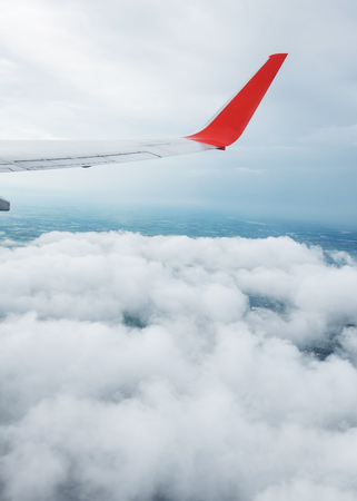 Close up of Wing of an airplane with blue sky clouds.の写真素材