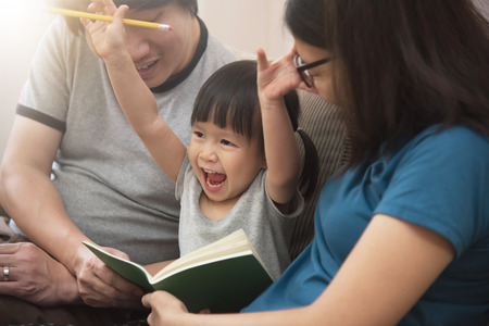 Cheerful of Asian family with young father, mother and little kid girl.