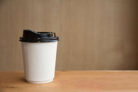 Close up of A cup of hot coffee on wooden background with copy space. Takeaway.の写真素材