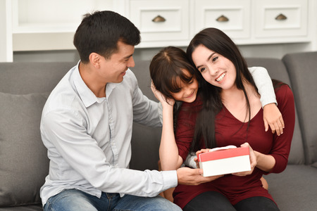 Happiness of young family holding gift box for celebration on New year, Birthday, Christmas.の写真素材