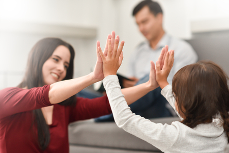 Happy family Laughing. Young mother playing with daughter at home.の写真素材