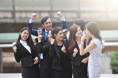 Happiness Group Of Business People Celebrating with arm raised up at outdoor. Successful Concept.の写真素材