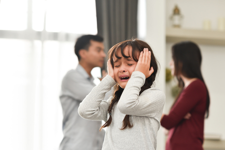 Sadness Little Kid Girl crying and screaming over Couple or her Parent conflicting. Unhappy Family Divorce concept.の写真素材
