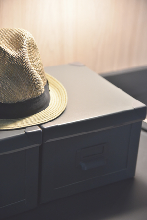 Close up Straw hat on dark brown treasure boxes.