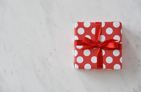 Top view of Red gift box on white marble background for Christmas and New year. Copy space.の写真素材