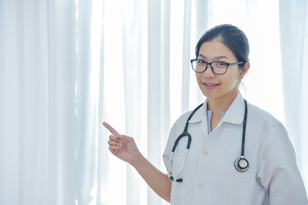 Portrait of a beautiful Asian Female Doctor smiling. copy space.の写真素材