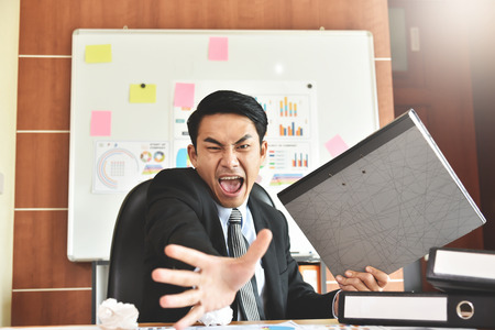 Depressed Angry Young Asian Businessman is yelling. Angry. Stress.の写真素材