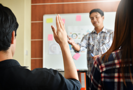 Confident Asian Creative male Designer making a new business presentation project to a group.の写真素材