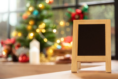 Empty Chalkboard over christmas tree background with copy space.の写真素材