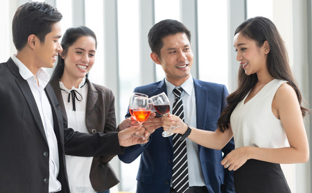 Great deals and Celebration! Group of Business People Toasting with red wine after meeting about new projects.の写真素材
